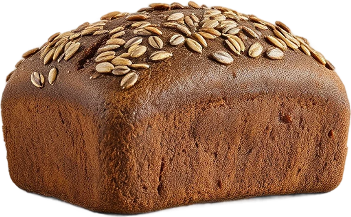 A dark seeded rye loaf baked in a tin, topped with sunflower seeds